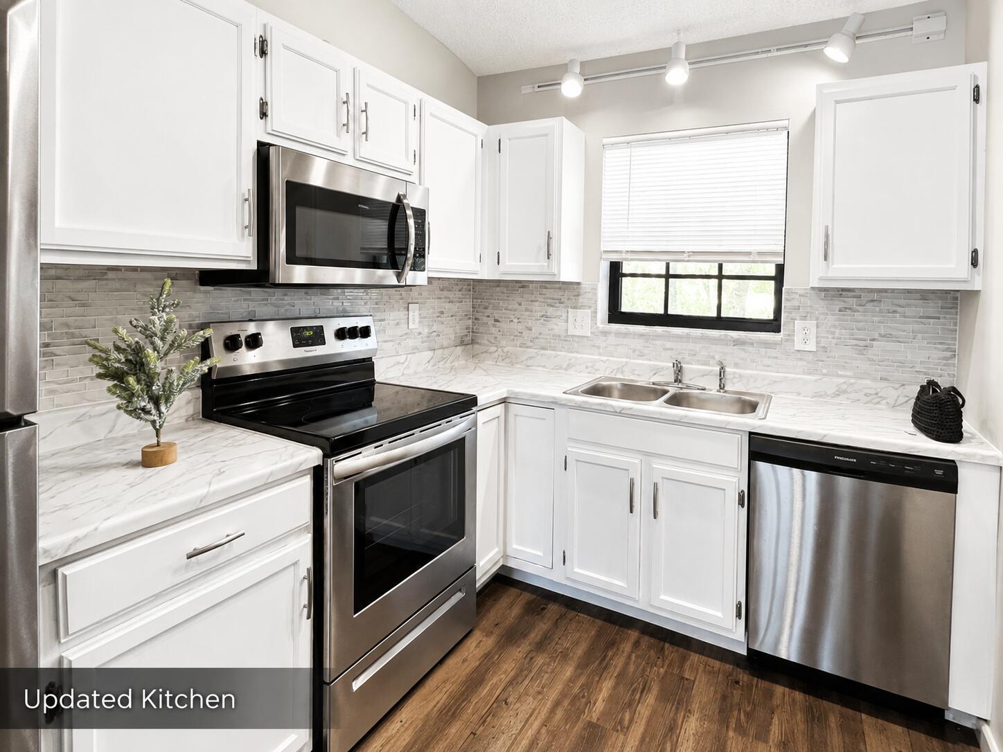 2650 Greenwood Terrace, Unit 2230 Boca Raton, FL 33431 - Photo 6 of 21 a kitchen with a sink stove and microwave