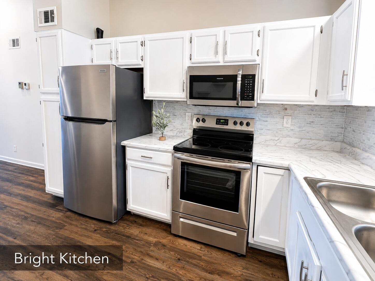 2650 Greenwood Terrace, Unit 2230 Boca Raton, FL 33431 - Photo 7 of 21 a kitchen with stainless steel appliances a stove a microwave and a sink