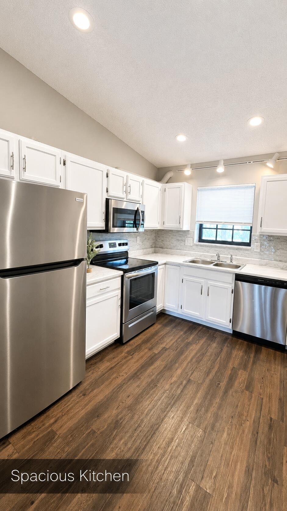 2650 Greenwood Terrace, Unit 2230 Boca Raton, FL 33431 - Photo 8 of 21 a kitchen with stainless steel appliances granite countertop a refrigerator a stove top oven a sink and dishwasher with wooden floor