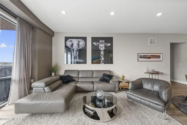 a living room with furniture and a painting