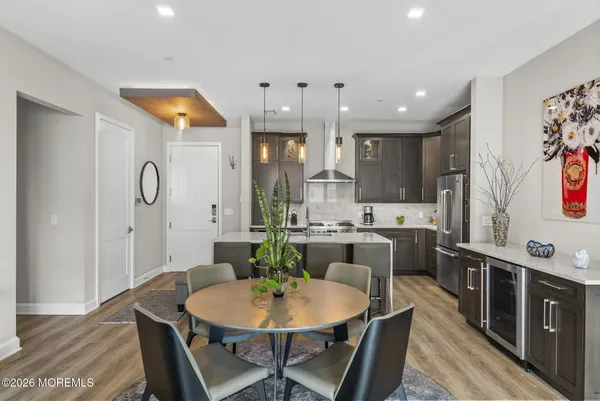 a dining room with furniture and wooden floor