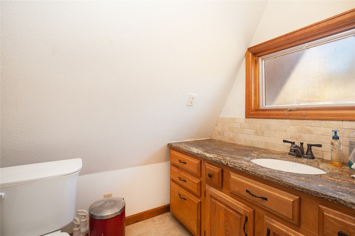 97 Rd G Silverthorne, CO 80498 - Photo 11 of 26 a bathroom with a granite countertop sink vanity mirror and toilet