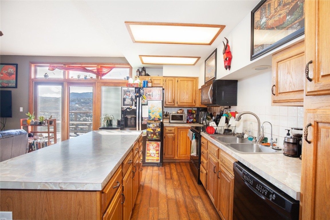 97 Rd G Silverthorne, CO 80498 - Photo 7 of 26 a kitchen with stainless steel appliances granite countertop a sink a stove and a wooden floors
