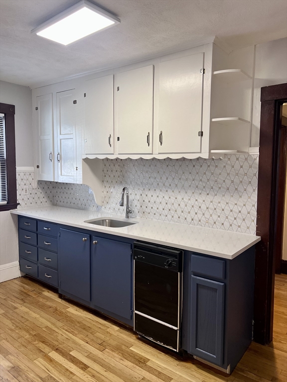 a kitchen with stainless steel appliances granite countertop a sink and cabinets