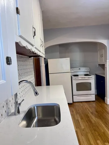 a kitchen with a sink a stove and refrigerator
