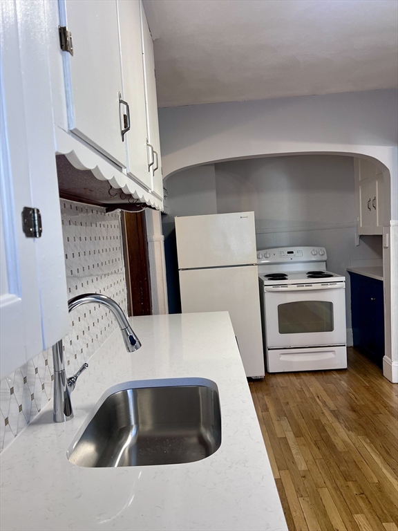 264 Boston Street, Unit 3 Lynn, MA 01904 - Photo 2 of 6 a kitchen with a sink a stove and refrigerator