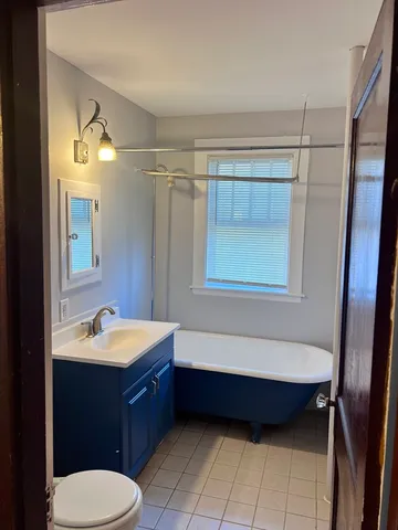 a bathroom with a sink a toilet and bathtub