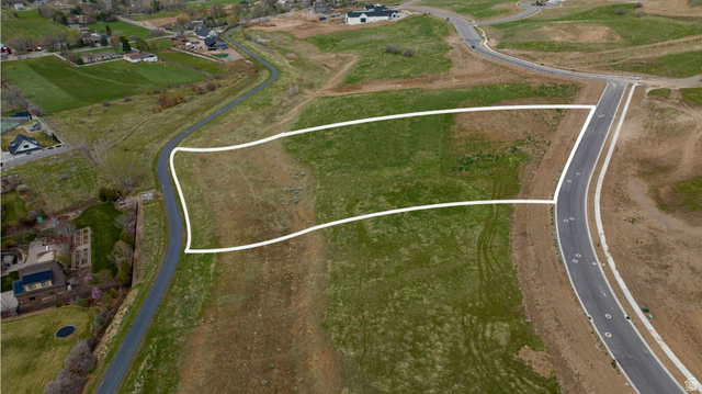 2042 Valley Drive, Unit 57 Mapleton, UT 84664 - Photo 6 of 18 Expansive undeveloped land parcel featuring a paved road frontage, established curb cuts, and surrounding green space
