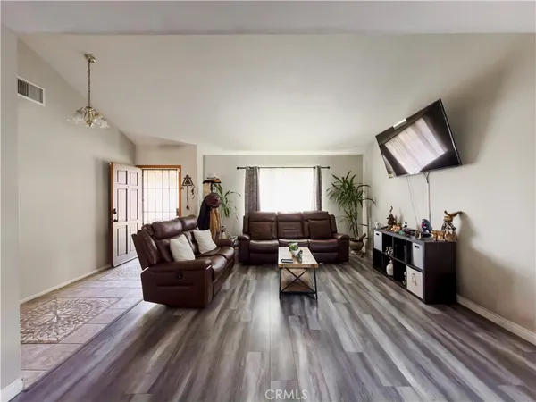 a living room with furniture and a chandelier