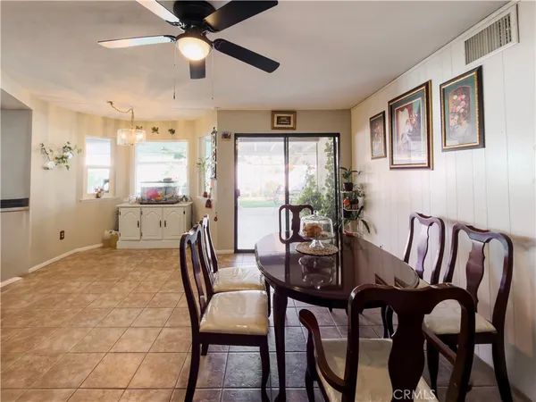 a living room with furniture and a dining table