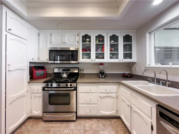 a kitchen with granite countertop a stove and a sink