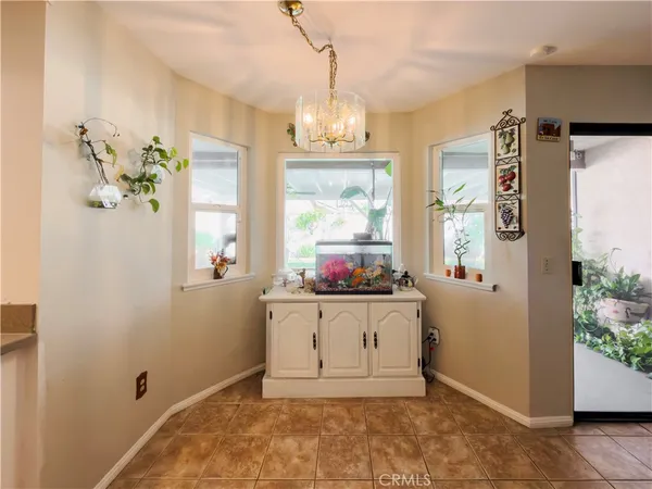 a kitchen with granite countertop a stove top oven microwave and cabinets