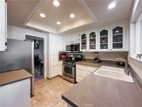 a kitchen with cabinets appliances and a window