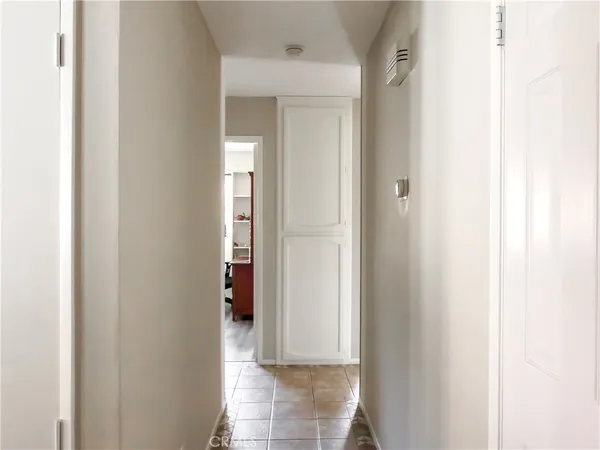 a spacious bedroom with a bed and a flat screen tv