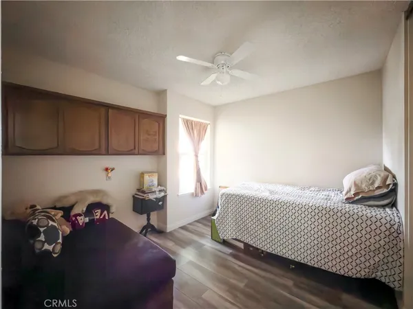 a bedroom with a bed and a desk