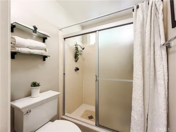a bathroom with a toilet sink vanity and mirror