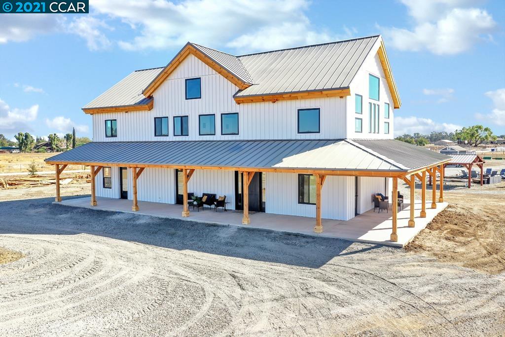 a front view of house with yard and seating space