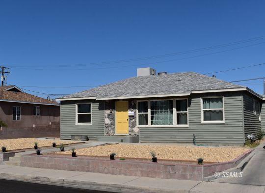 316 Balsam Street Ridgecrest, CA 93555 - Photo 1 of 16 a front view of a house with garage and parking