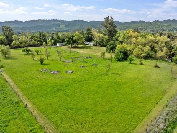 a view of an lush green hillside and houses