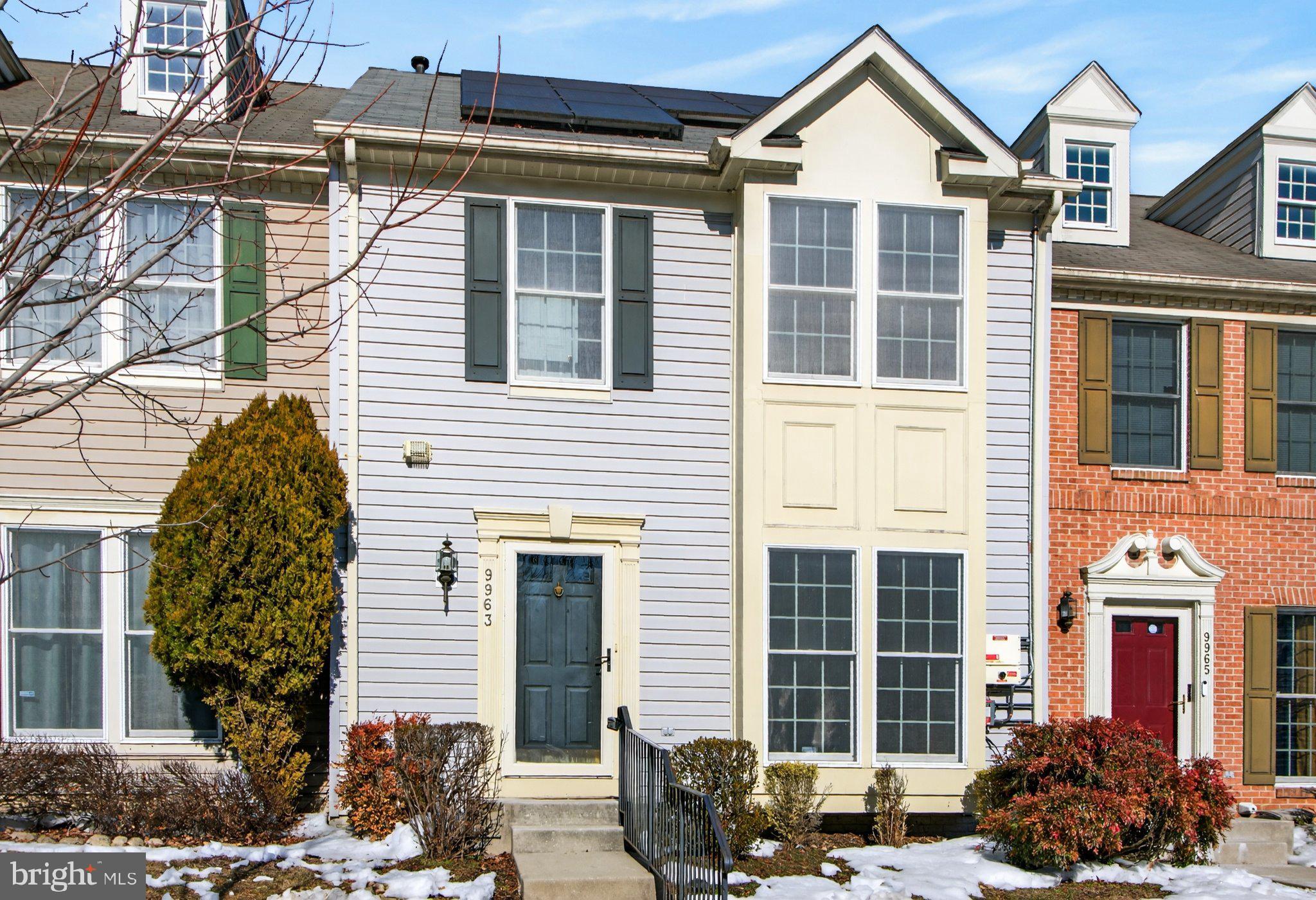 a front view of a residential apartment building with a yard