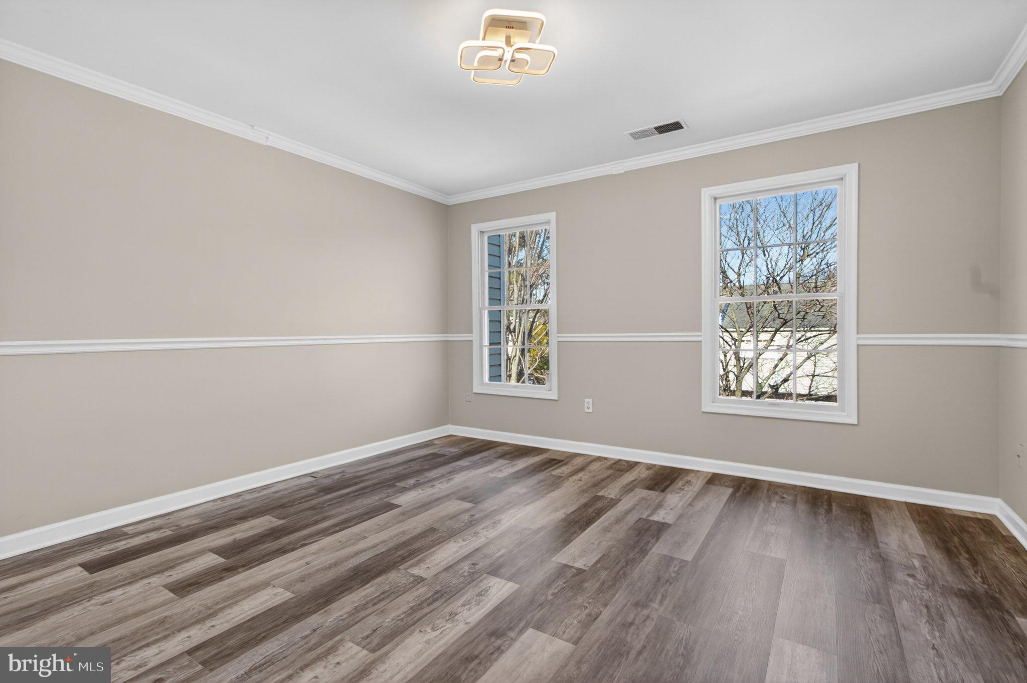 9963 Sherwood Farm Road Owings Mills, MD 21117 - Photo 35 of 48 a view of an empty room with wooden floor and a window