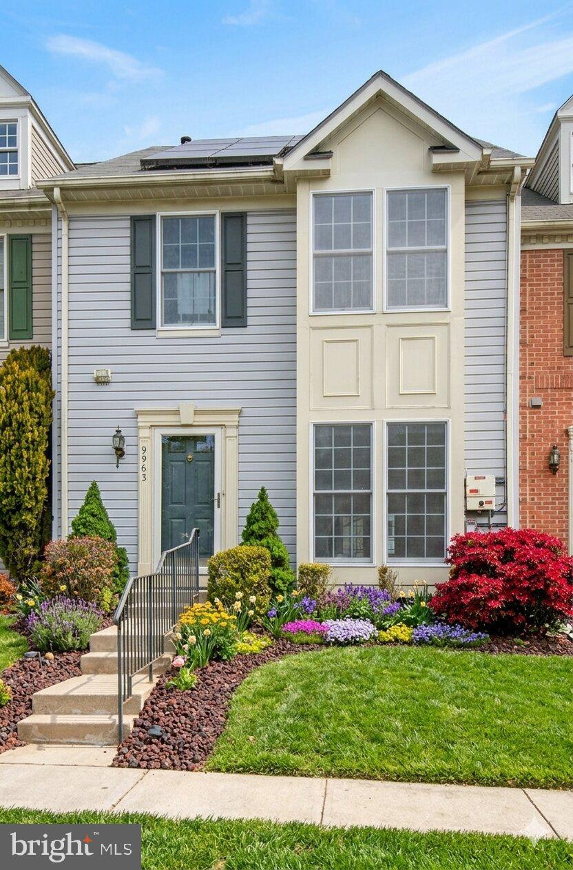 9963 Sherwood Farm Road Owings Mills, MD 21117 - Photo 4 of 48 a front view of a house with a garden and plants