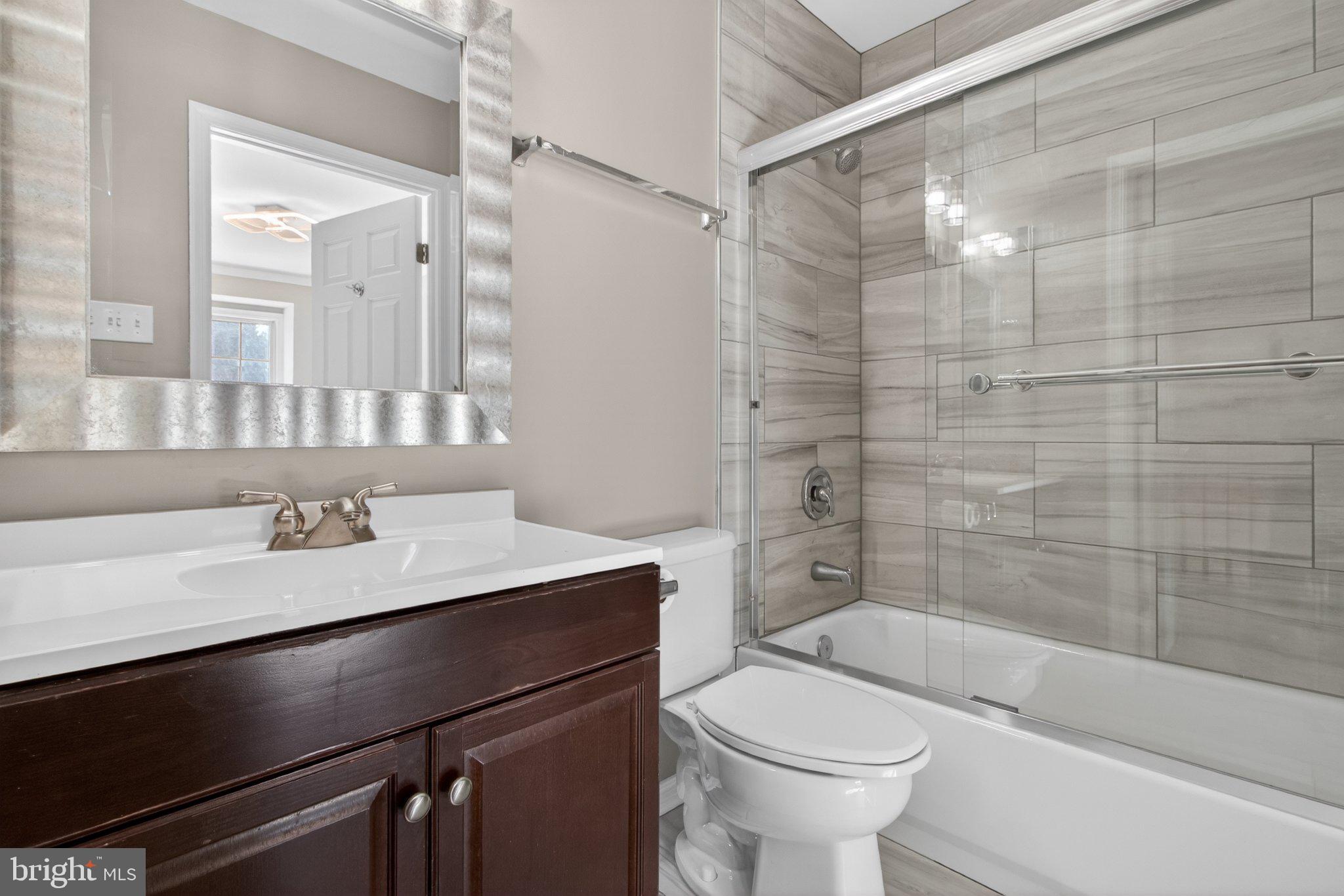 9963 Sherwood Farm Road Owings Mills, MD 21117 - Photo 44 of 48 a bathroom with a sink a toilet and shower