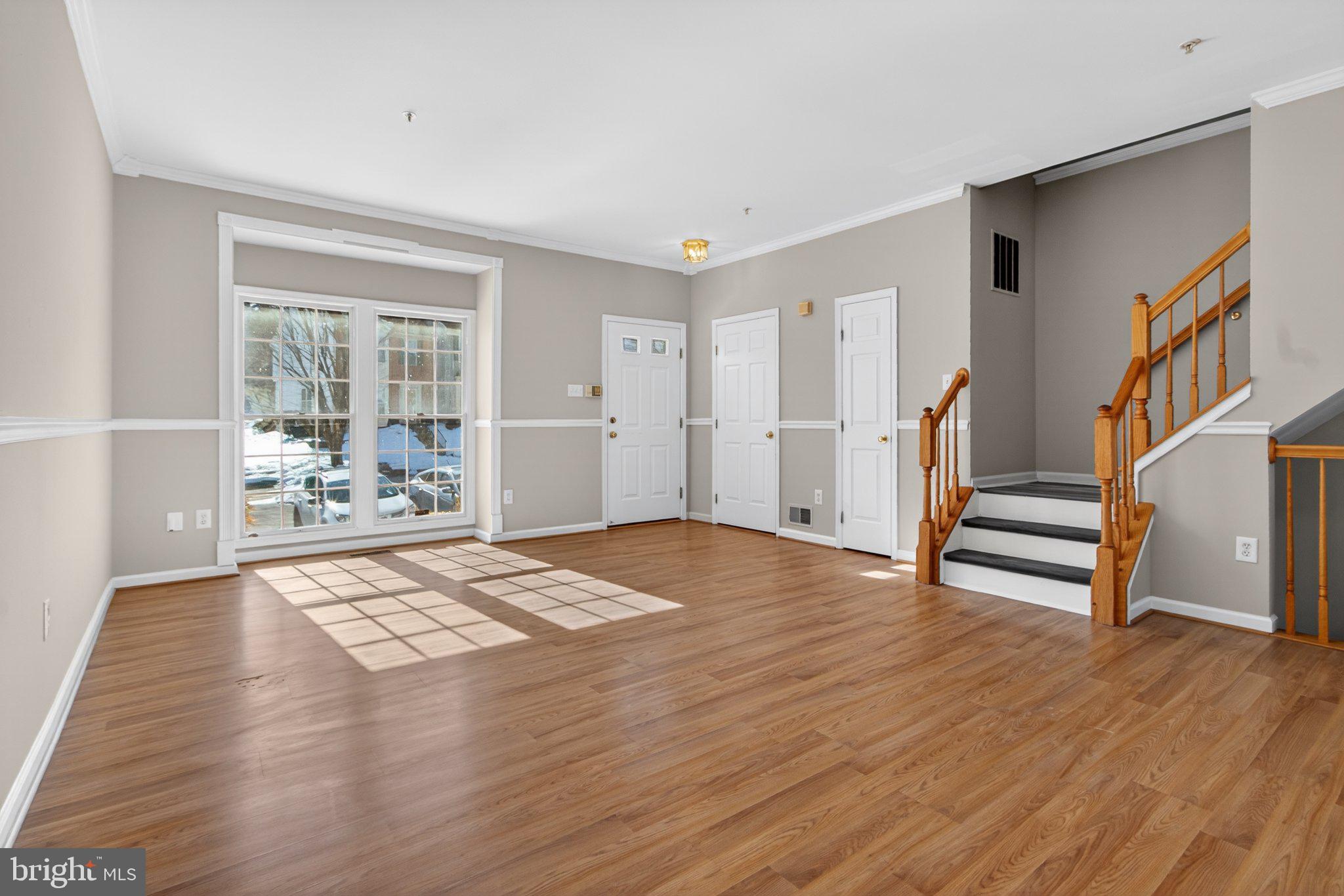 9963 Sherwood Farm Road Owings Mills, MD 21117 - Photo 7 of 48 a view of an empty room with wooden floor and a window