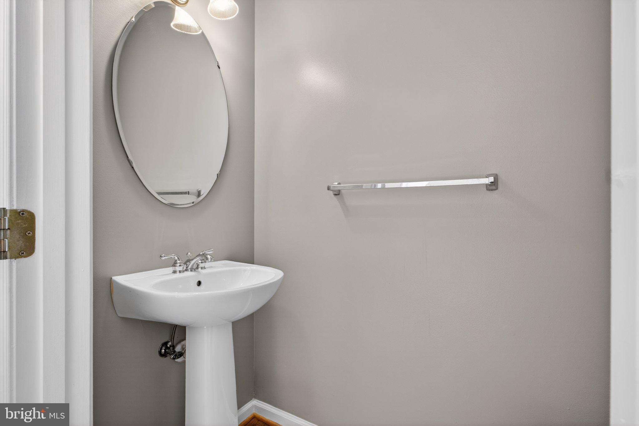 9963 Sherwood Farm Road Owings Mills, MD 21117 - Photo 9 of 48 a bathroom with a sink and a mirror