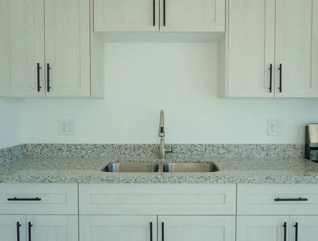 a kitchen with a sink and cabinets
