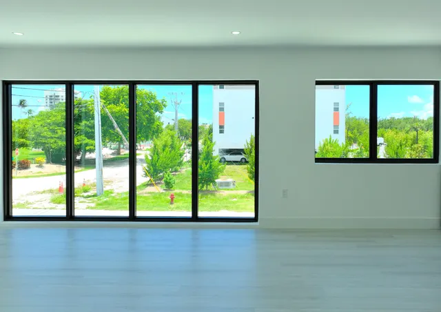 a view of an empty room with large windows