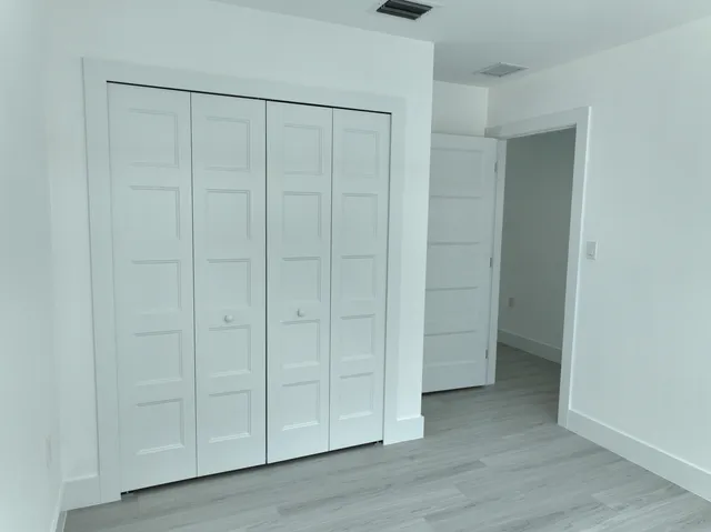 an empty room with closet area