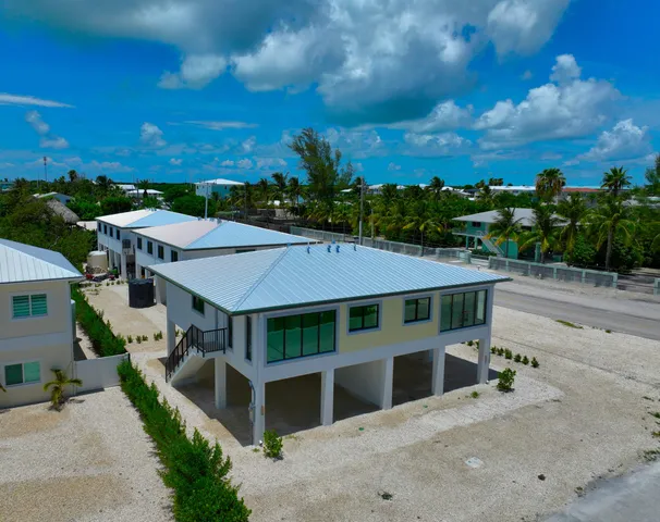 a view of a house with a yard balcony and furniture