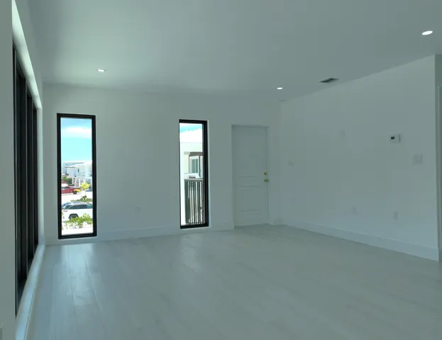 an empty room with windows and closet