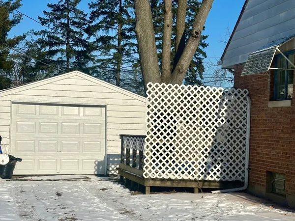 a front view of a house with a parking space