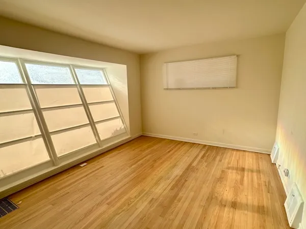 a view of an empty room and a window