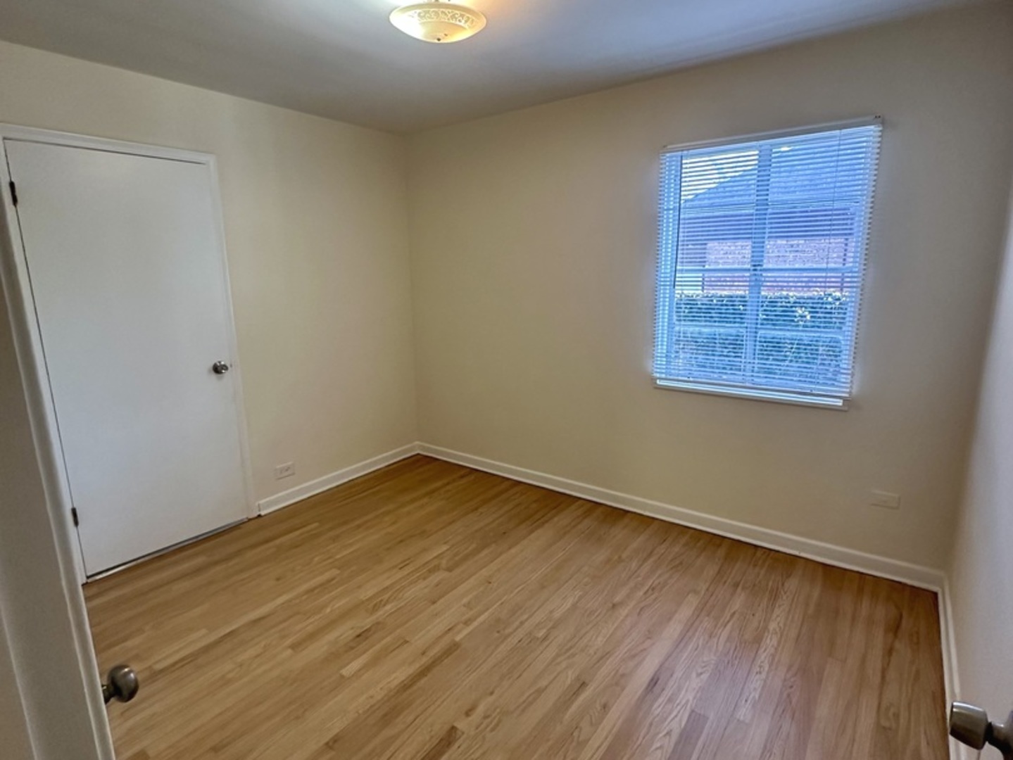 2156 Downey Road Homewood, IL 60430 - Photo 10 of 18 a view of an empty room with wooden floor and a window