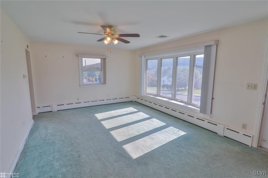403 Keystone Avenue Emmaus, PA 18049 - Photo 15 of 29 an empty room with chandelier fan and windows