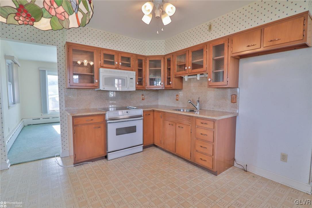 403 Keystone Avenue Emmaus, PA 18049 - Photo 10 of 29 a kitchen with stainless steel appliances granite countertop a stove and a sink