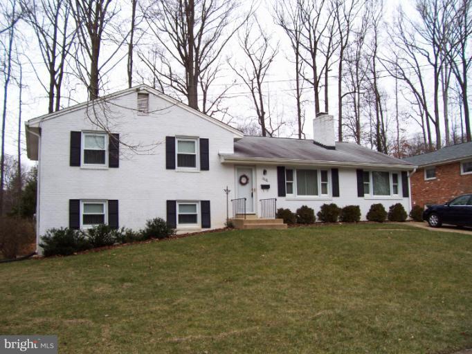 5636 Heming Avenue Springfield, VA 22151 - Photo 1 of 30 a view of a white house with large trees and couches chairs
