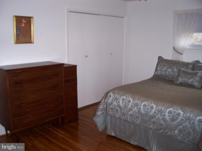 5636 Heming Avenue Springfield, VA 22151 - Photo 11 of 30 a bedroom with a bed and a night stand