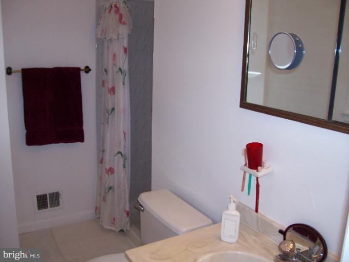 5636 Heming Avenue Springfield, VA 22151 - Photo 12 of 30 a bathroom with a toilet and a shower