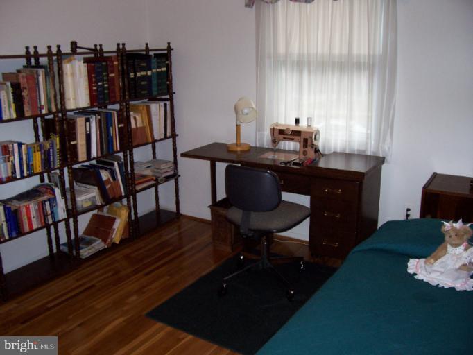 5636 Heming Avenue Springfield, VA 22151 - Photo 13 of 30 a room with a table chairs and a book shelf