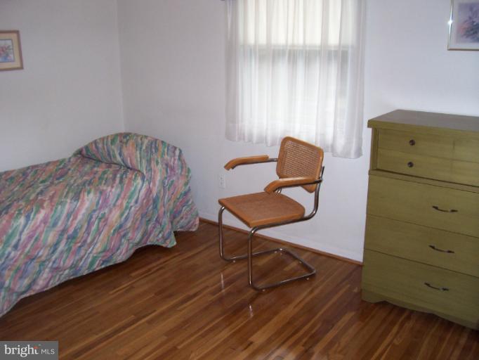 5636 Heming Avenue Springfield, VA 22151 - Photo 19 of 30 a bedroom with a bed and chair