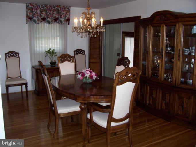 5636 Heming Avenue Springfield, VA 22151 - Photo 23 of 30 a dining room with furniture a chandelier and wooden floor