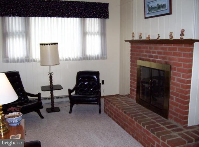 5636 Heming Avenue Springfield, VA 22151 - Photo 5 of 30 a living room with furniture and a fireplace