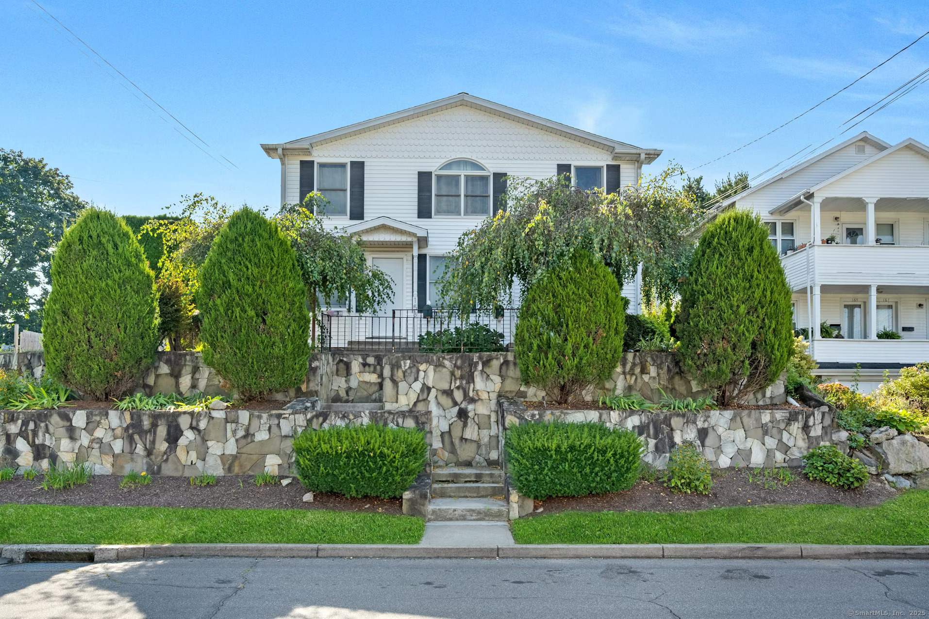 a front view of a house with a garden