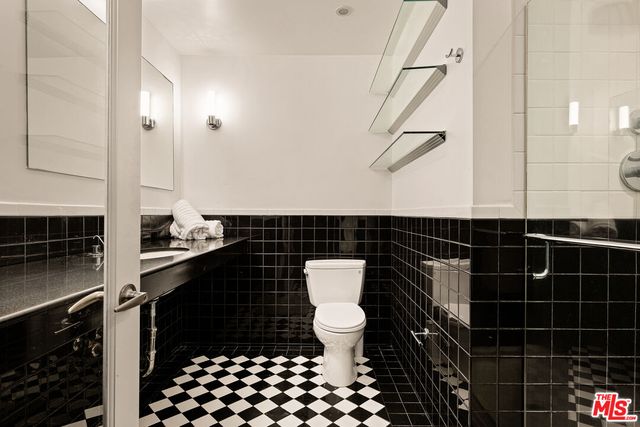 a bathroom with a sink a toilet and a mirror