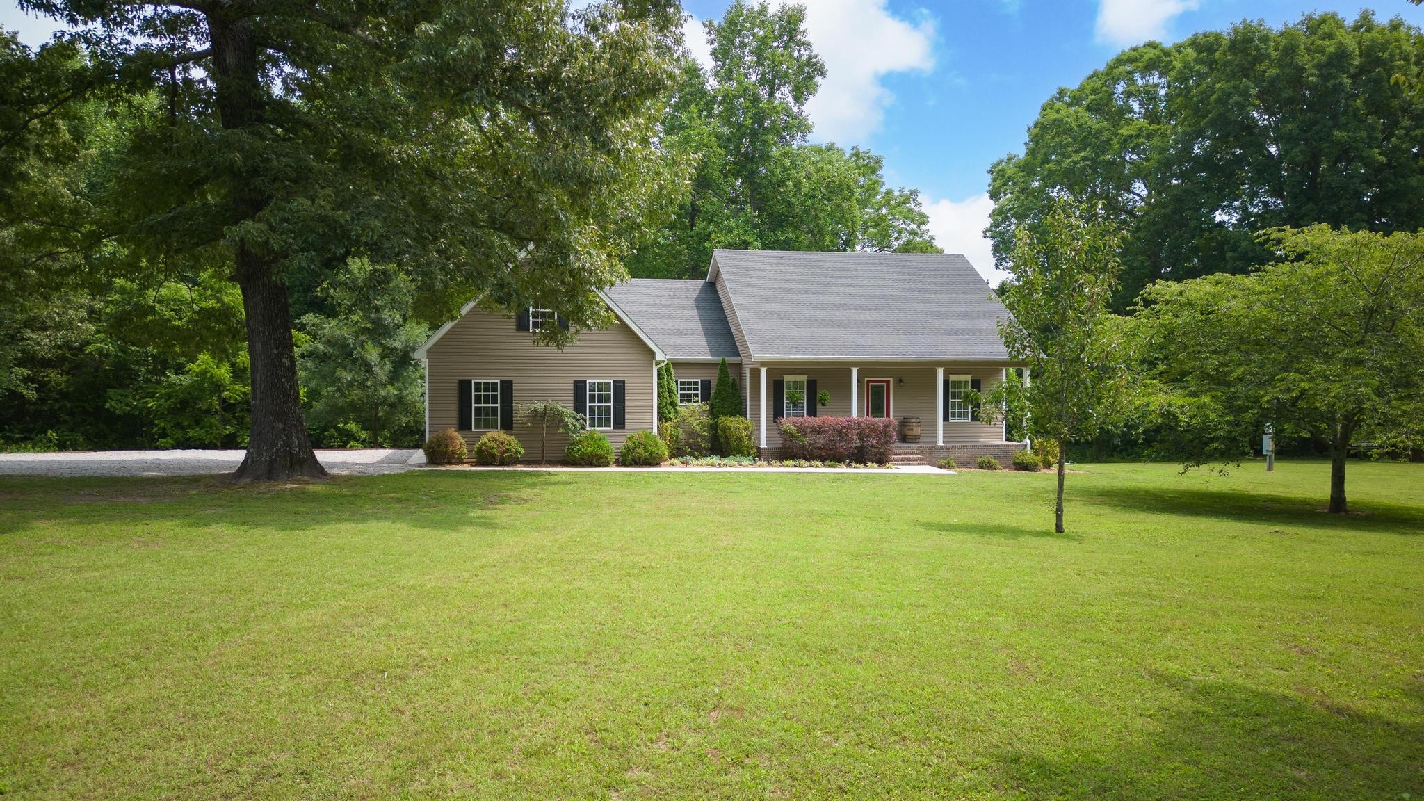 16 Shasteen Ridge Road Lynchburg, TN 37352 - Photo 2 of 55 a house with a big yard and large trees