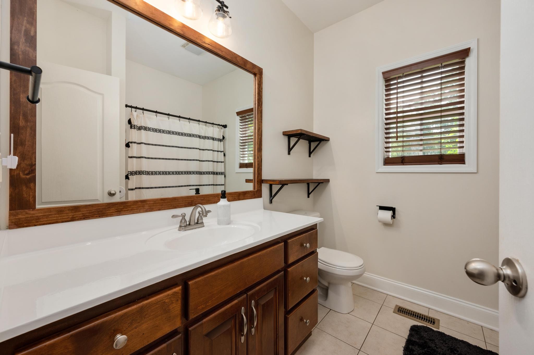 16 Shasteen Ridge Road Lynchburg, TN 37352 - Photo 23 of 55 a bathroom with a sink a toilet and mirror